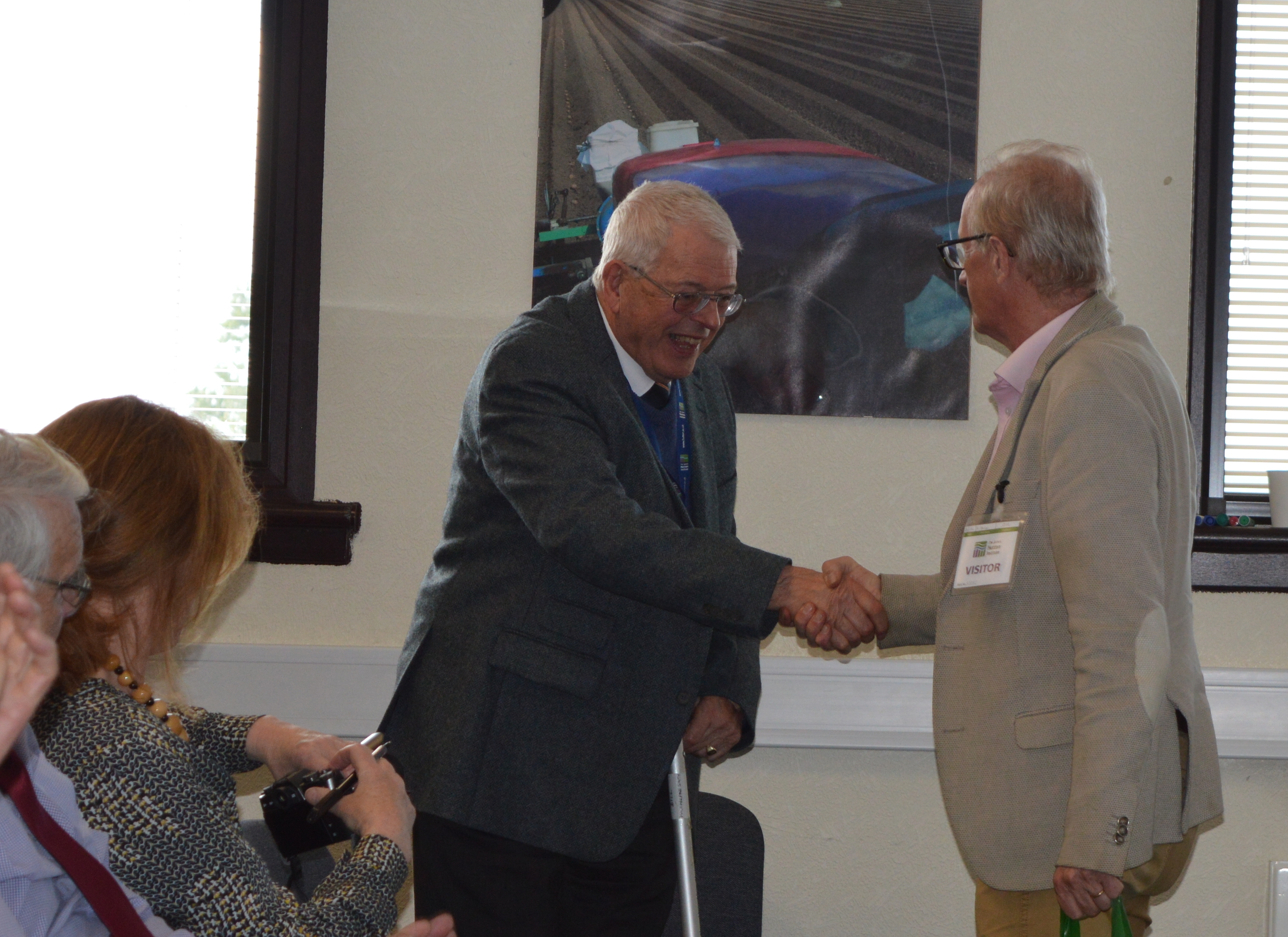 Dr Bill Macfarlane Smith (left) receives a gift from SSCR chair Dr Keith Dawson